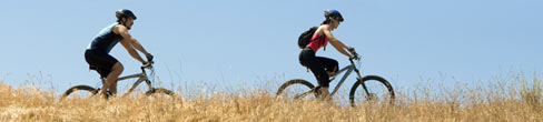 Two adults cycling in the countryside
